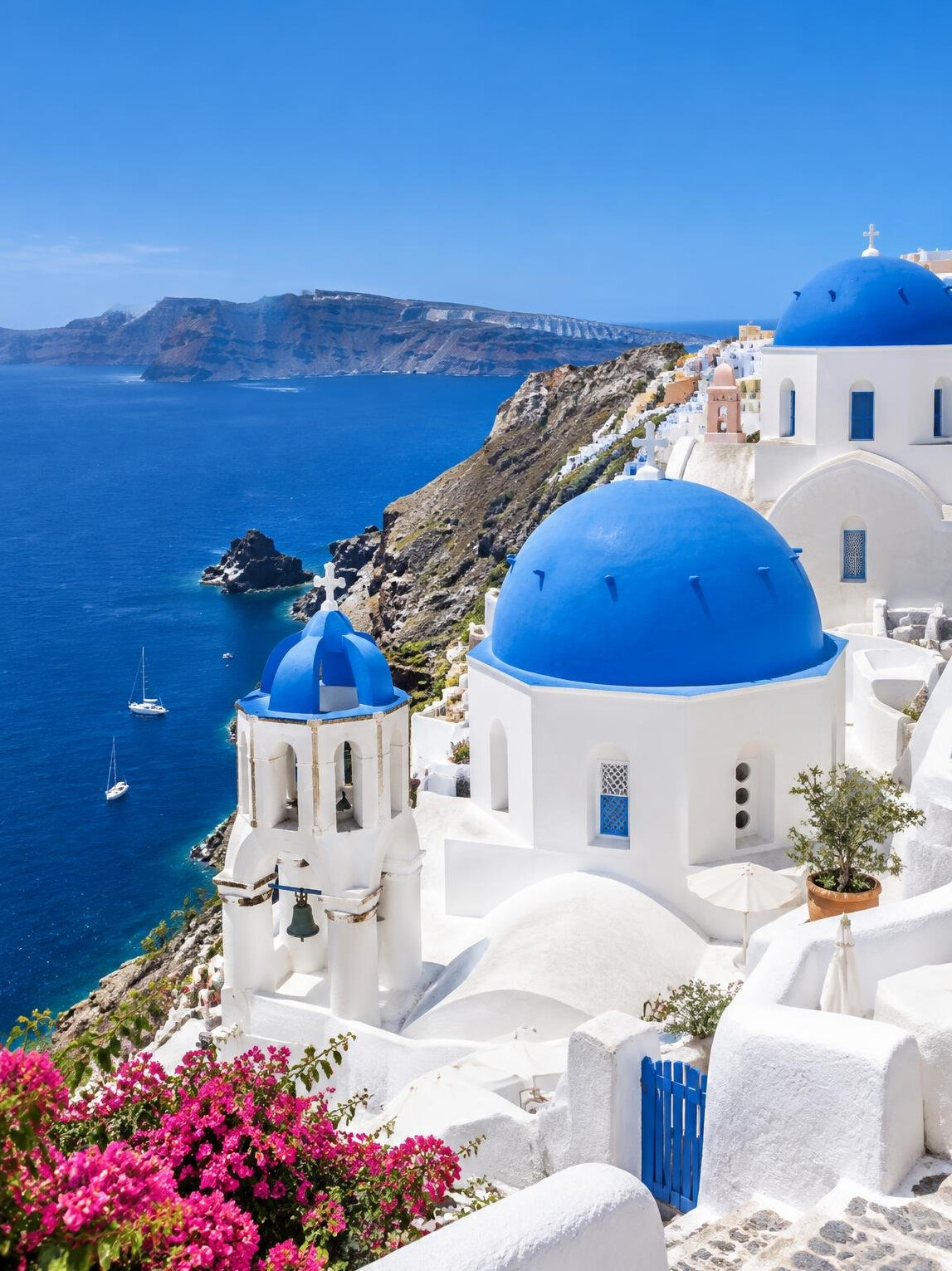 White houses and blue domes of Santorini above the sea
